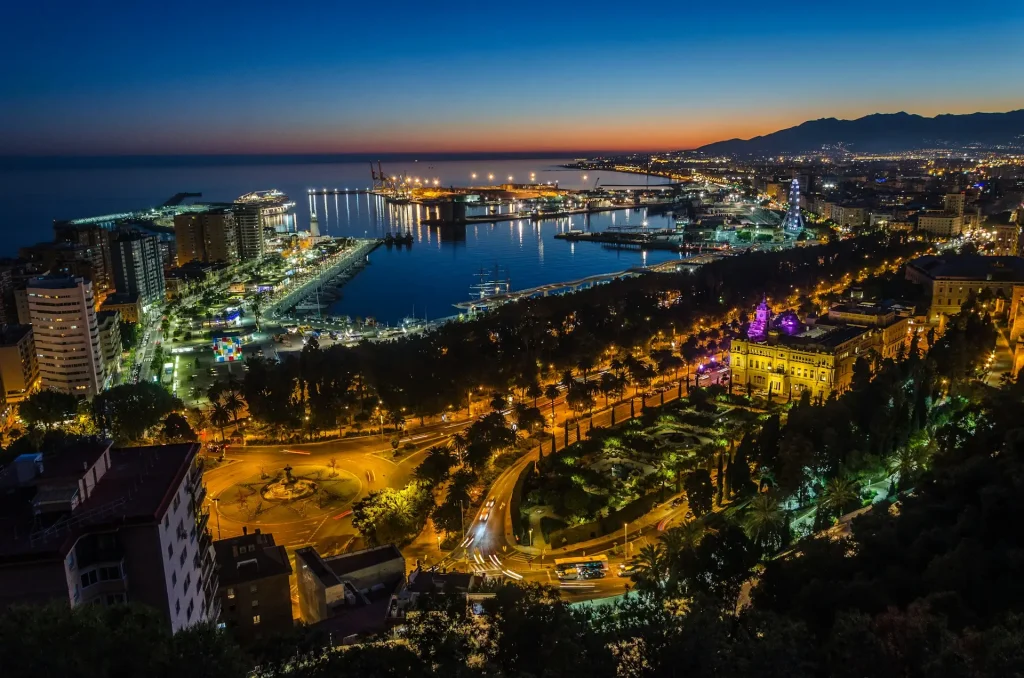Breathtaking panoramic view of Málaga's coastline highlighting key landmarks featured in our comprehensive 5 Days in Málaga Itinerary, including the historic Alcazaba fortress, Mediterranean beaches, and vibrant harbor.