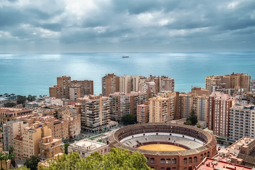 Panoramic sunset view of Malaga's skyline showcasing essential landmarks to explore with Malaga travel tips.